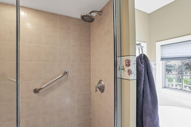 bathroom with a shower stall and a washtub