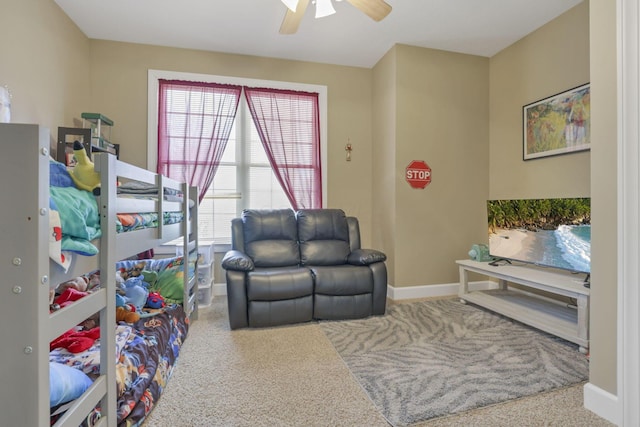 interior space featuring ceiling fan, baseboards, and carpet flooring