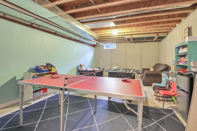 game room featuring brick wall