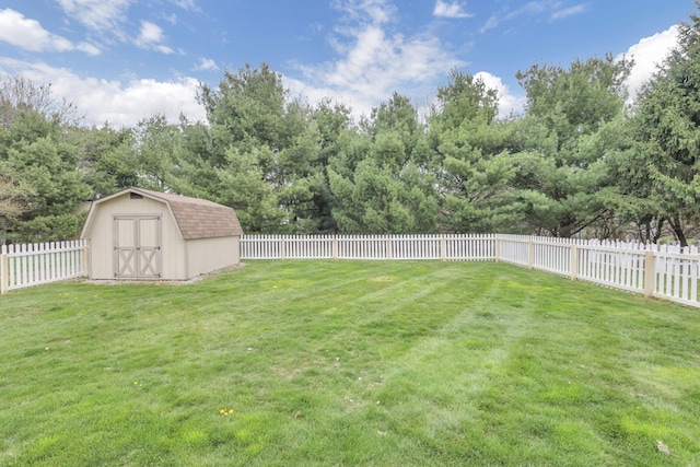 view of yard with an outbuilding, a fenced backyard, and a shed