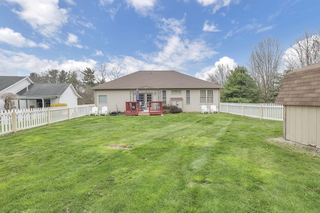 back of house featuring a yard, a fenced backyard, and a wooden deck