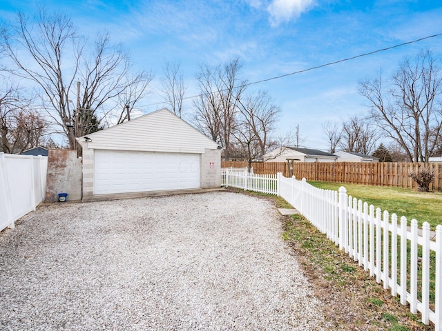 detached garage featuring fence