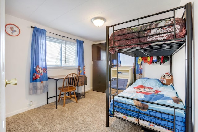 carpeted bedroom featuring baseboards