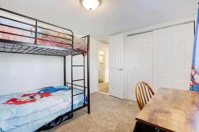 bedroom featuring a closet and light carpet