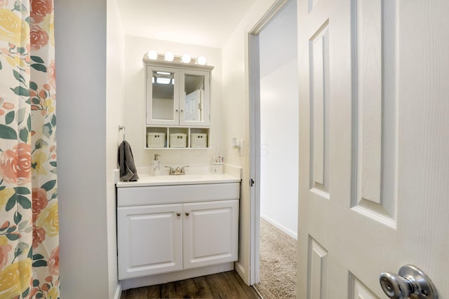 bathroom with wood finished floors and vanity