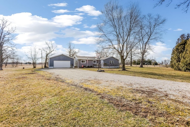 ranch-style home with a garage, a front yard, and driveway