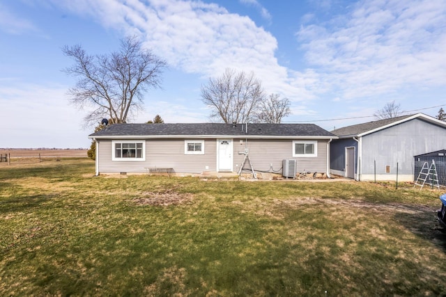 back of property with cooling unit, crawl space, a lawn, and fence