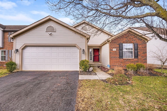 ranch-style house with driveway, brick siding, a front lawn, and an attached garage