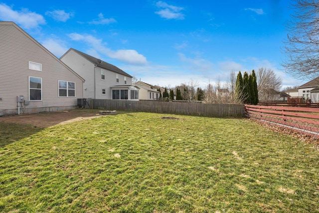 view of yard with a patio area, a fenced backyard, and central AC