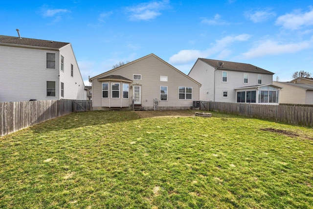 back of property featuring entry steps, a fenced backyard, a yard, and central air condition unit