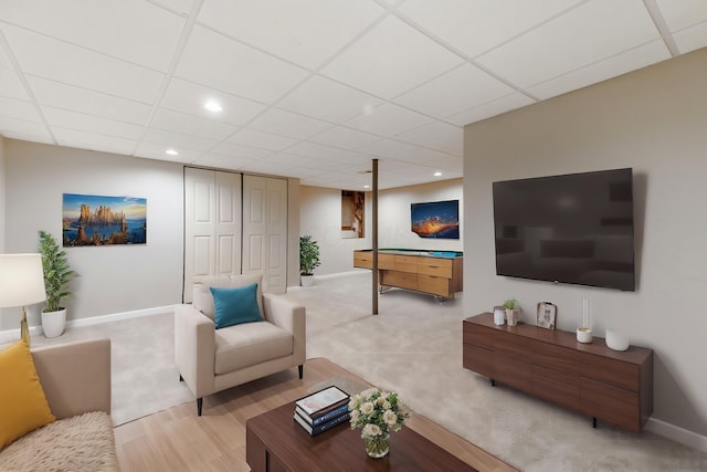 living room with a paneled ceiling, baseboards, light colored carpet, and recessed lighting