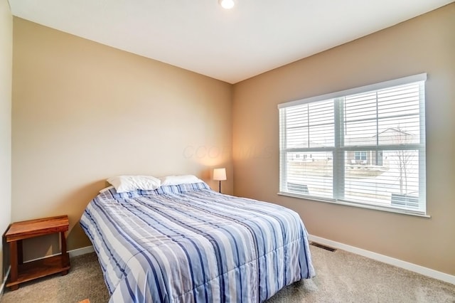 bedroom with multiple windows, carpet, and baseboards