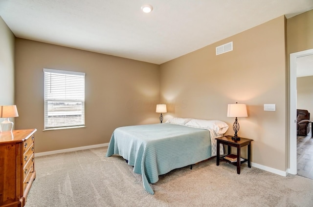 carpeted bedroom featuring visible vents and baseboards