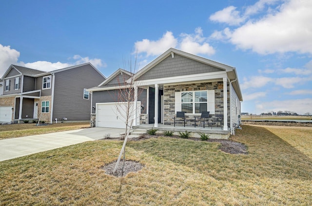 view of front facade featuring concrete driveway, stone siding, an attached garage, covered porch, and a front yard