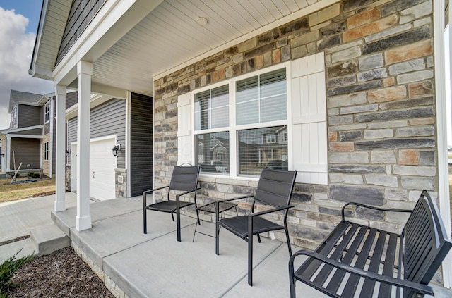 view of patio / terrace with covered porch and a garage