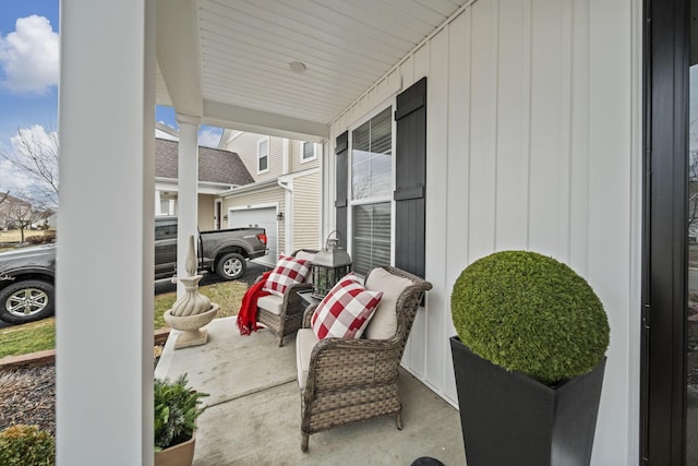 view of patio / terrace featuring a garage and covered porch