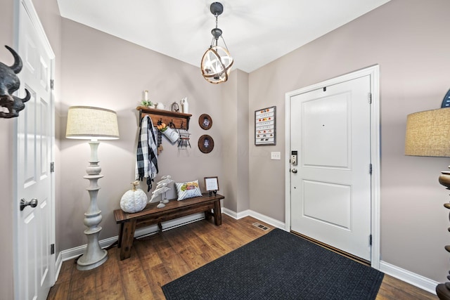 foyer entrance featuring baseboards and wood finished floors