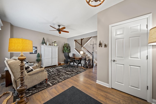 interior space featuring stairway, wood finished floors, a ceiling fan, and baseboards