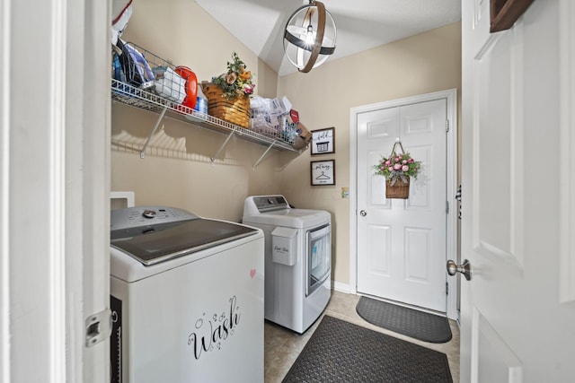 laundry room featuring laundry area, tile patterned flooring, and separate washer and dryer