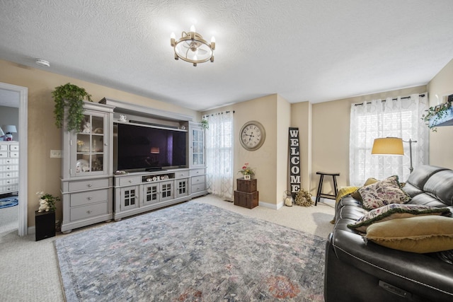 carpeted living area with a textured ceiling and baseboards