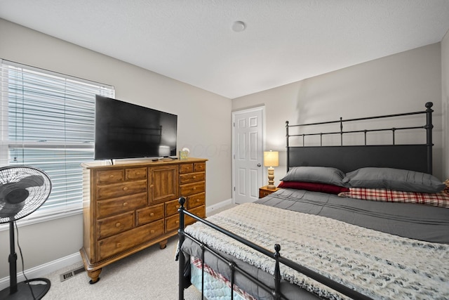 bedroom featuring light colored carpet, visible vents, and baseboards