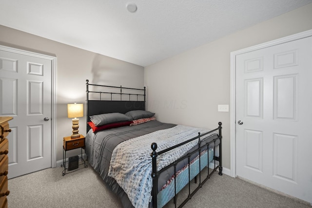 bedroom with carpet floors and baseboards