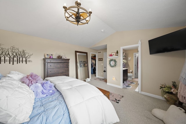 carpeted bedroom with lofted ceiling, ensuite bathroom, a notable chandelier, baseboards, and a spacious closet