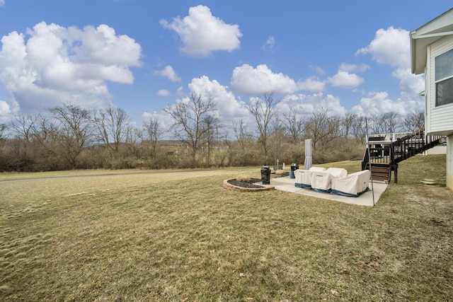 view of yard featuring stairs and a patio