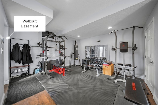 exercise area with recessed lighting, a textured ceiling, and baseboards