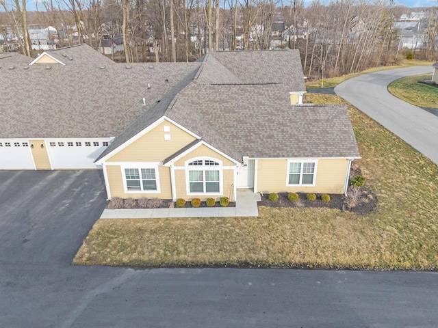 view of front facade with a garage, aphalt driveway, and a shingled roof