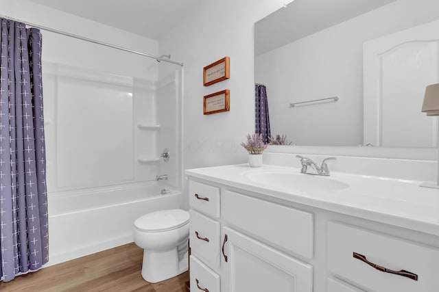 bathroom featuring toilet, shower / bath combo, wood finished floors, and vanity