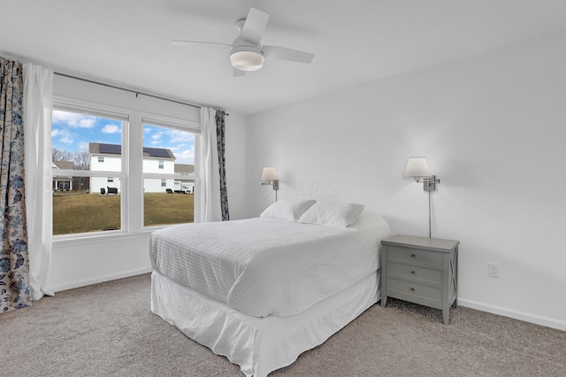 carpeted bedroom featuring ceiling fan and baseboards