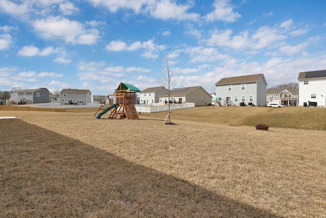 community play area featuring a residential view and a yard