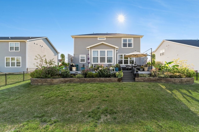 back of property featuring a patio area, fence, and a lawn