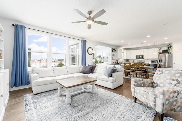 living room featuring ceiling fan, wood finished floors, and recessed lighting