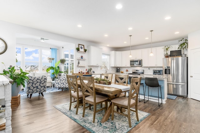 dining area with plenty of natural light, wood finished floors, and recessed lighting