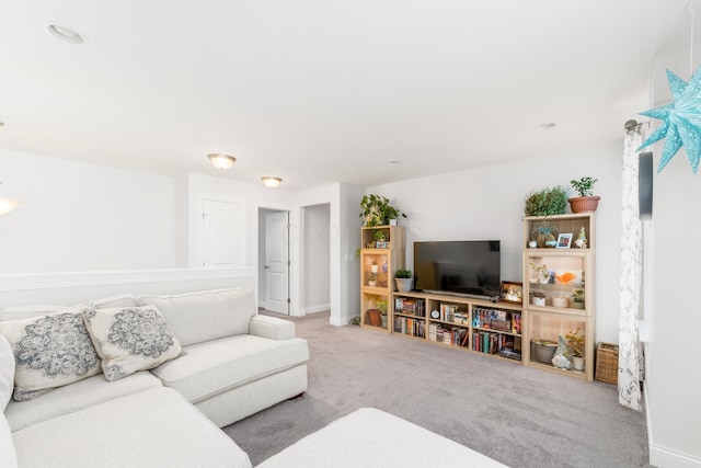 carpeted living area featuring baseboards