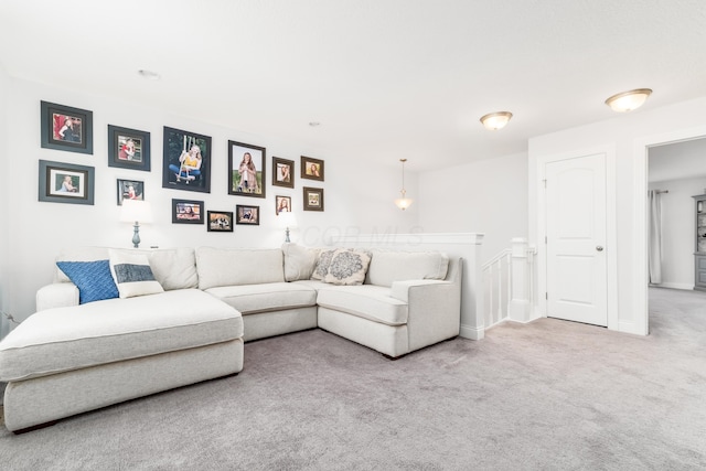 carpeted living room with baseboards