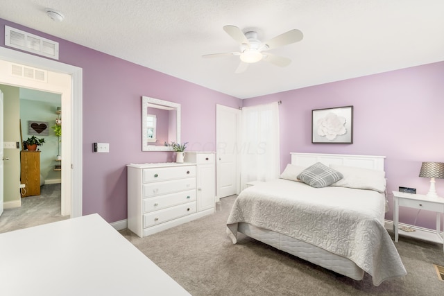 bedroom featuring baseboards, visible vents, ceiling fan, and light colored carpet