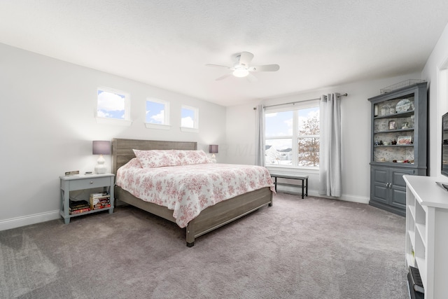 bedroom with carpet floors, ceiling fan, a textured ceiling, and baseboards