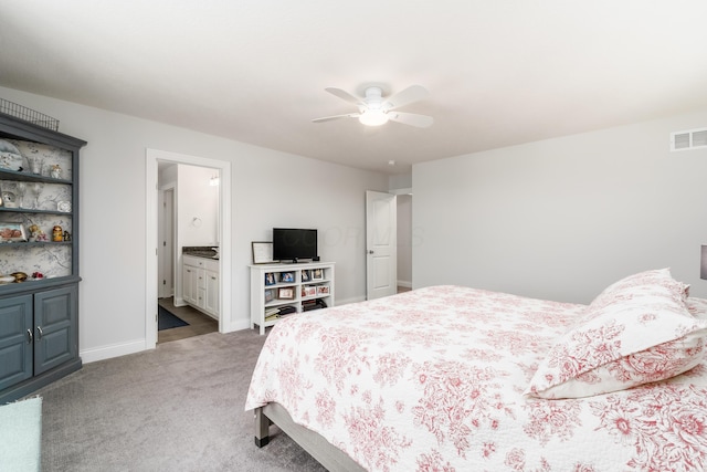 carpeted bedroom featuring connected bathroom, visible vents, ceiling fan, and baseboards