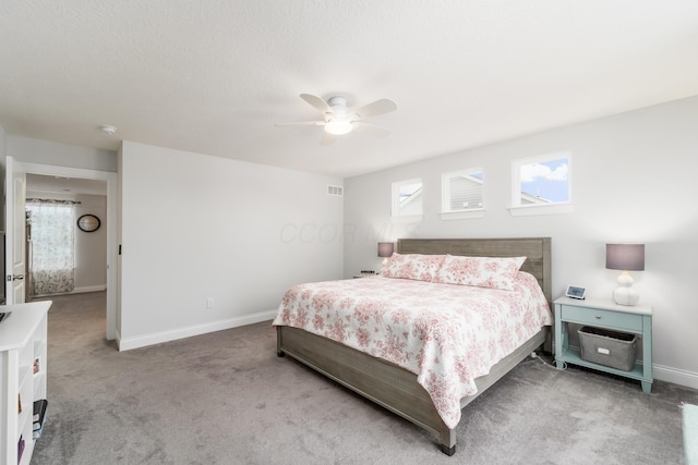 bedroom featuring carpet floors, visible vents, baseboards, and a ceiling fan