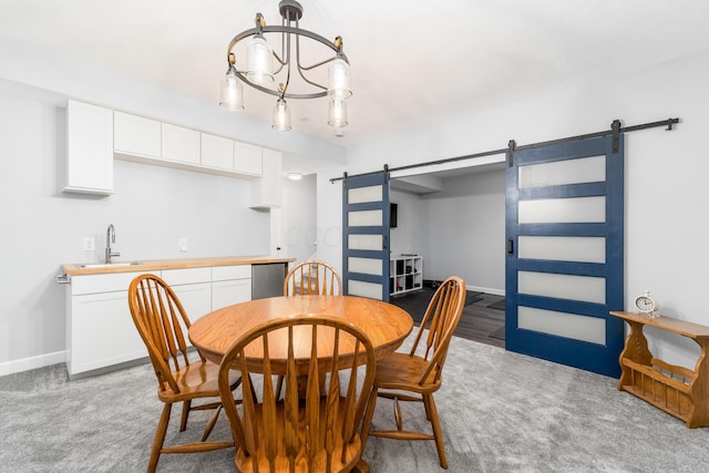 dining area featuring light colored carpet, a notable chandelier, baseboards, and a barn door