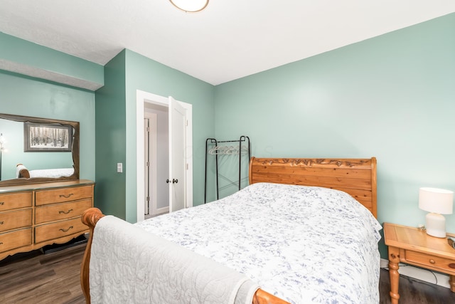 bedroom with dark wood finished floors