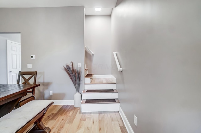 stairs with baseboards and wood finished floors