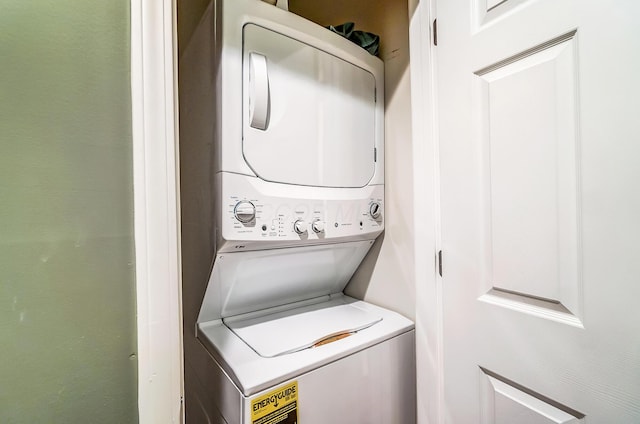 laundry area featuring stacked washing maching and dryer and laundry area