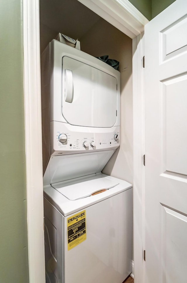 washroom with stacked washer / dryer and laundry area