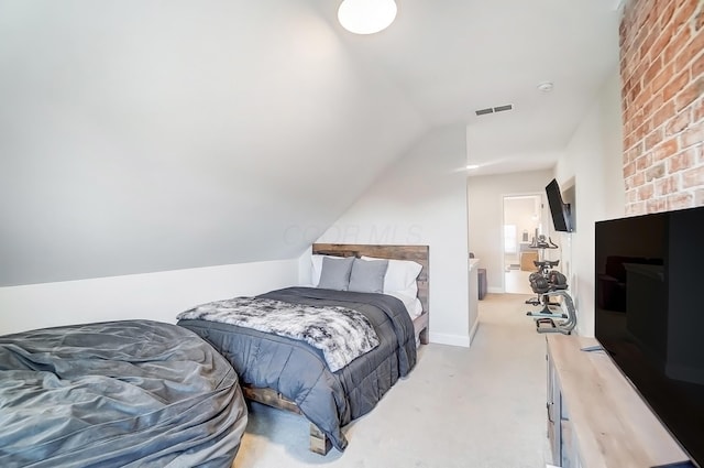 bedroom with visible vents, vaulted ceiling, and light carpet