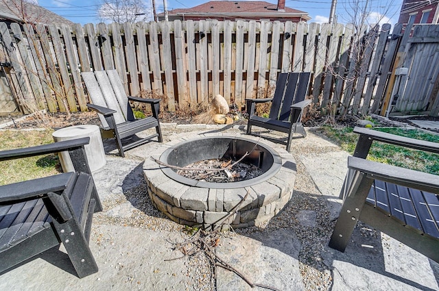 view of patio featuring fence and a fire pit