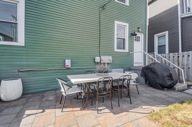 view of patio / terrace featuring fence, outdoor dining area, and area for grilling